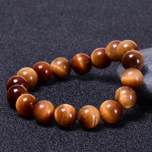 Macro view of natural tiger eye stone beads showing glossy texture and cat-eye effect