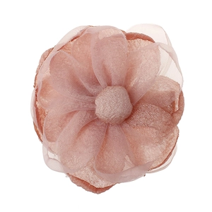 Close-up of pink layered fabric flower hair clip with delicate tulle petal texture