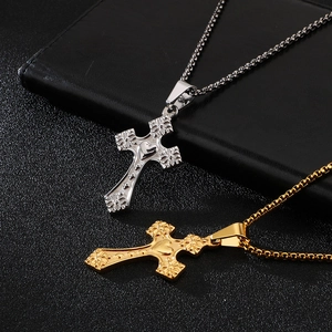 Polished silver and gold cross pendants with floral engraving and heart center detail