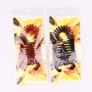 Detail of black and brown banana hair clips with multi-tooth design in retail packaging
