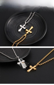 Detailed close-up of gold and silver cross necklaces with polished rope chains for men