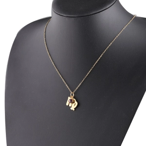 Detail of Virgo zodiac gold necklace with purple birthstone on black mannequin