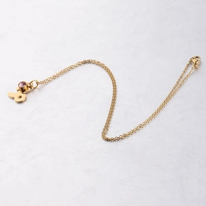 Gold plated zodiac necklace with pink birthstone pendant on minimalist link chain