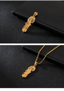 Detail view of a gold Virgin Mary pendant with clear crystals on a box chain