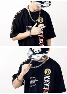 Detail of silver and black Byzantine chain necklace and bracelet on male model