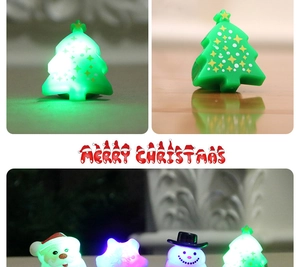 Macro view of LED Christmas rings showing tree, Santa, snowman and snowflake glow effects