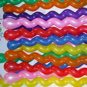 Top view of colorful thickened spiral latex balloons in various vibrant neon shades