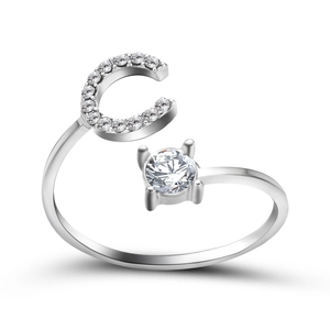Macro detail of silver adjustable open ring featuring crystal letter C and round solitaire
