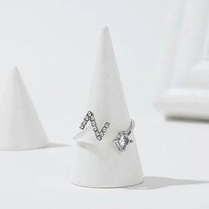 Macro shot of silver letter N adjustable ring with sparkling white cubic zirconia stones
