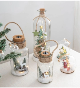 Detail of Nordic glass Christmas lanterns with warm LED lights and miniature snow scenes