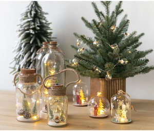 Detail of Christmas glass lamp with snowy scene, reindeer silhouette and warm LED light