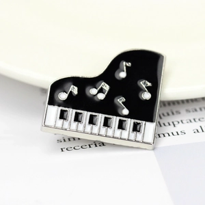 Exquisite black and white enamel piano brooch with silver music notes for clothing decor