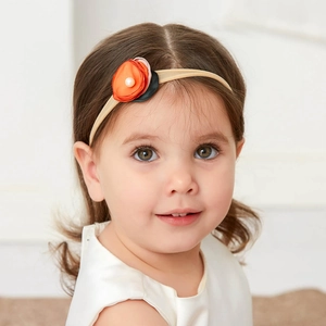 Detail view of baby floral headband with orange and pink flowers and pearl accents
