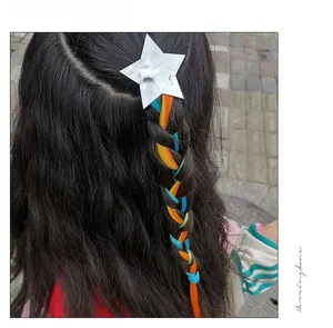 Star-shaped hair clip with colorful gradient hair extensions worn on a girl's braid