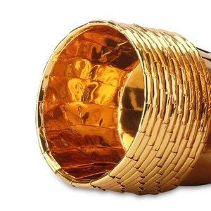 Detailed view of golden paper baking cups with luxury metallic woven texture