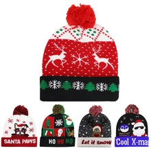 Close-up of assorted Christmas knit beanies with festive embroidery and pom-poms