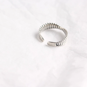 Close-up of S925 sterling silver mobius ring with striped texture on white background