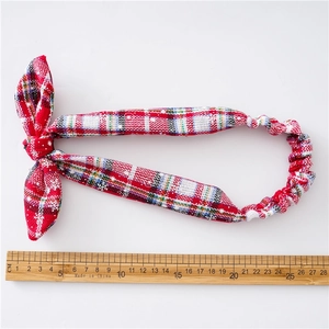 Red plaid Christmas headband with snowflake patterns and bowknot on white background