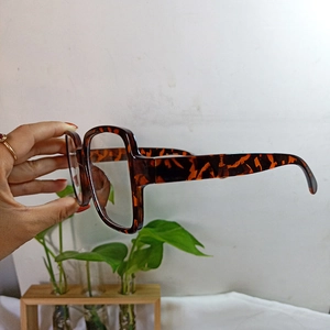Detail view of retro tortoise shell square eyeglass frame with thick temples