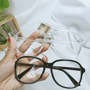 Detail shot of oversized retro glasses frames in black and transparent candy colors
