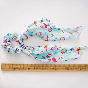 Christmas blue ribbon scrunchie with Santa and snowman patterns and measurement ruler