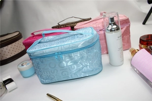 Detail view of large capacity makeup bags in pink and blue with elegant SIGNE SO patterns