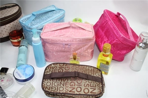 Top view of assorted waterproof travel toiletry bags with handles and SOIGNE lettering