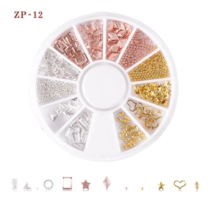 Detail showing mixed metal moon and star nail art studs in a 12-slot storage wheel