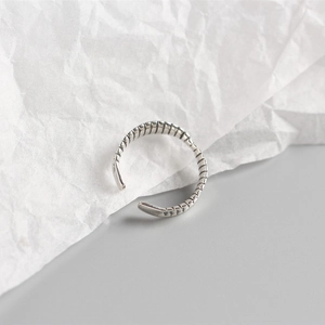 Detailed close-up of S925 sterling silver mobius twist ring with vintage bone texture