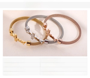 Detail view of woven stainless steel mesh bracelets with cross clasps in gold and silver