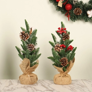 Mini Christmas trees with pine cones, cotton and red berries on a burlap base