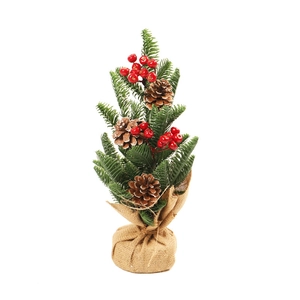 Mini Christmas tree with pine cones and red berries on a rustic burlap base
