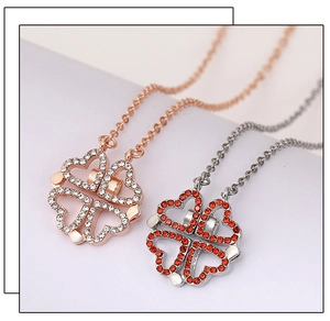 Detail of folding clover necklaces in rose gold and silver finish with crystal inlay