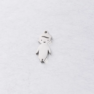 Macro shot of mirror-finish stainless steel boy and girl shaped pendants for DIY jewelry