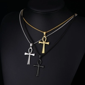 Three Ankh cross necklaces in gold, silver, and black finish on a professional bust