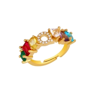 Detail of adjustable gold ring with multi-color gems and crystal pavé letter O motif
