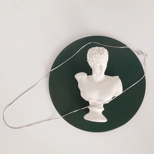 Minimalist 925 sterling silver snake chain necklace displayed on a white bust model