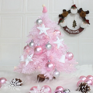 Pink desktop Christmas tree with LED lights ornaments and a natural wooden base