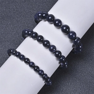 Detailed view of three blue goldstone bead bracelets showing starry glittering texture