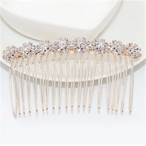 Elegant bridal hair comb with rhinestone sunflower design in a ceramic dish