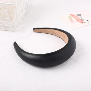 Macro shot of padded black leather headband featuring soft velvet lining for comfort