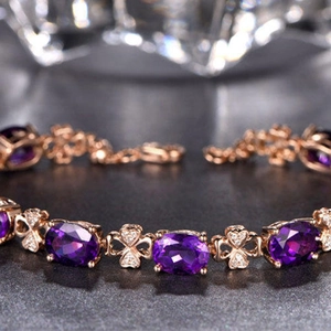 Rose gold bracelet with oval amethysts and heart links accented by fine diamonds