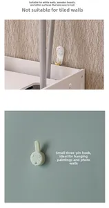 Installation guide for small white seamless wall hooks with three-pin design on boards