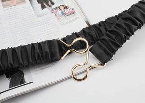 Detail of black pleated elastic waist belt featuring a gold alloy hook buckle