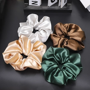 Set of four glossy satin scrunchies in silver, bronze, champagne, and emerald green