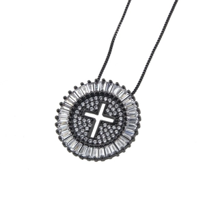 Close-up of circular hollow cross pendant with cubic zirconia and black gold plating