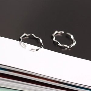 Detailed macro view of S925 sterling silver wavy rings with adjustable open band design