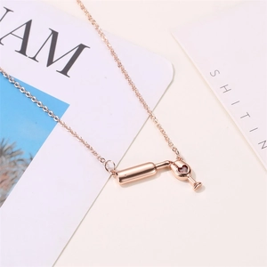 Rose gold wine bottle and glass necklace featuring a red heart pendant for women