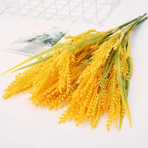 Detailed view of yellow artificial wheat stalks for wedding floral wall decoration