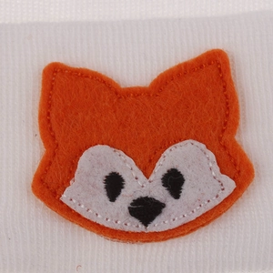 Detailed close-up of a fox cartoon embroidery patch on a baby knitted beanie hat